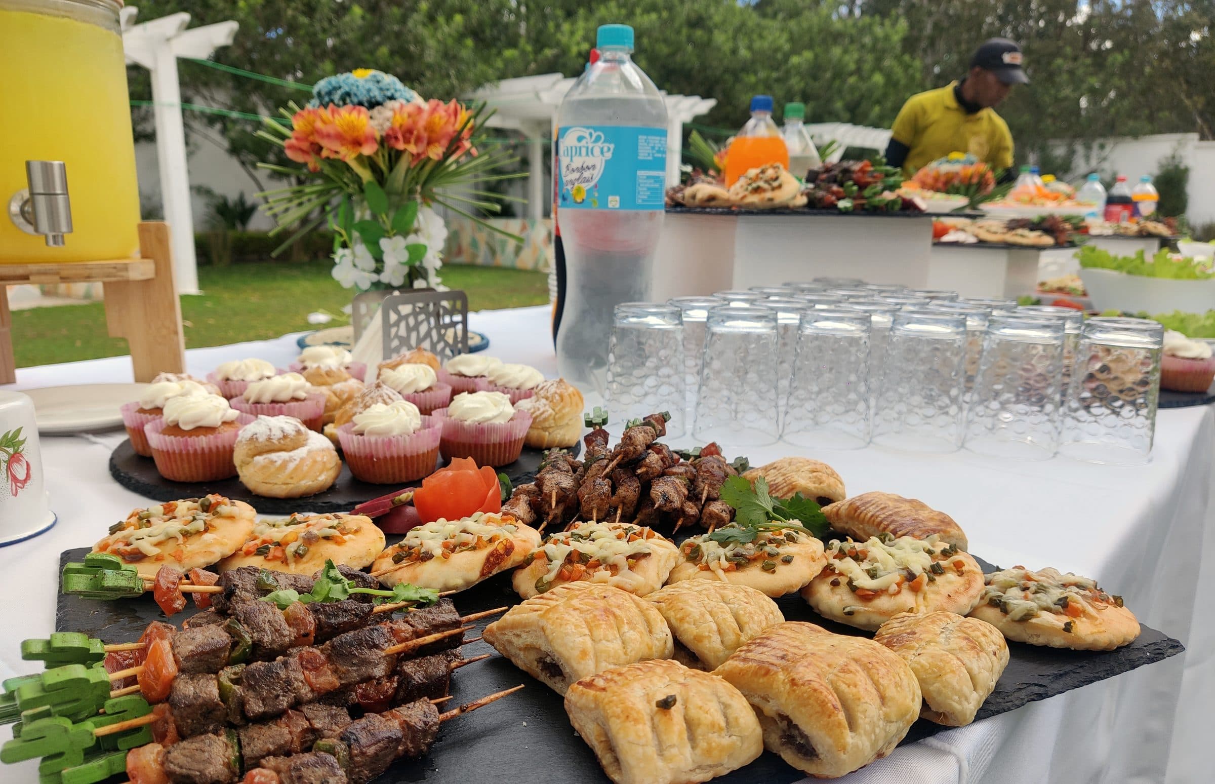 Buffet dressé dans le jardin : brochettes, cupcakes et feuilletés